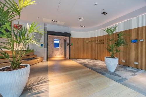 a hallway with two potted plants in a building at Crowne Plaza Utrecht - Central Station by IHG in Utrecht