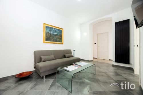 a living room with a couch and a coffee table at Airport 8 Minutes, 2BR, Terrace, By Tilo in Genova