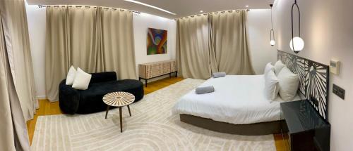 a hotel room with a bed and a chair at Villa Octagon Essaouira in Essaouira