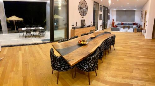 a large wooden table and chairs in a room at Villa Octagon Essaouira in Essaouira