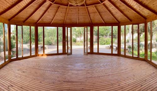 an empty pavilion with a wooden floor and windows at Villa Octagon Essaouira in Essaouira