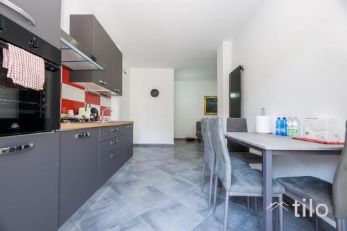 a kitchen with a table and chairs in a room at Airport 8 Minutes, 2BR, Terrace, By Tilo in Genova