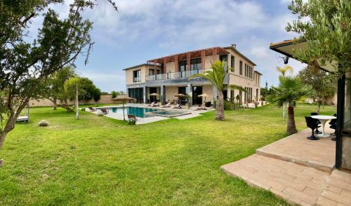 a large house with a swimming pool in a yard at Villa Octagon Essaouira in Essaouira
