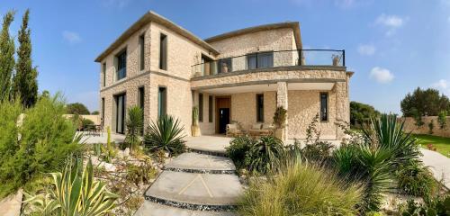 a stone house with a balcony on top of it at Villa Octagon Essaouira in Essaouira