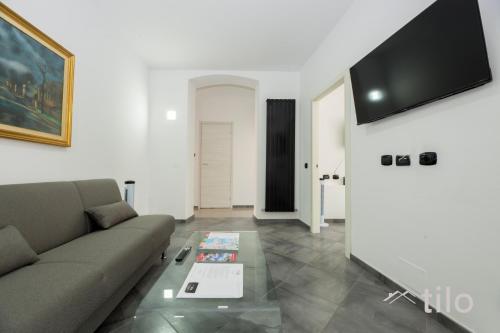 a living room with a couch and a table at Airport 8 Minutes, 2BR, Terrace, By Tilo in Genova