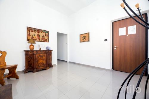 a hallway with a wooden door and a table at Airport 8 Minutes, 2BR, Terrace, By Tilo in Genova