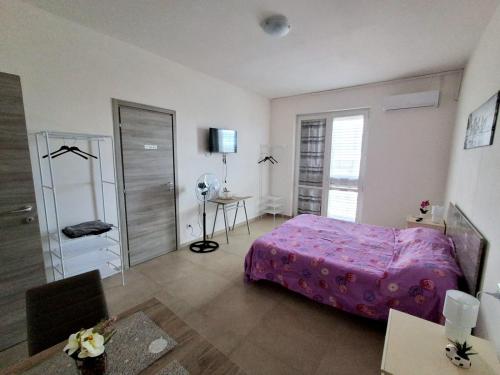 a bedroom with a bed and a table and a desk at Irpinia Verde in Mirabella Eclano