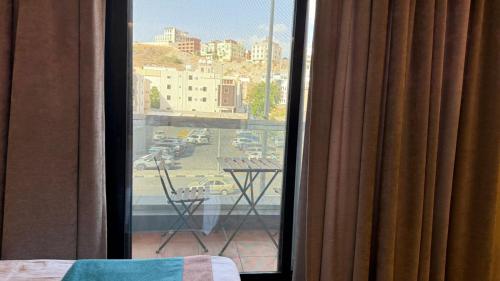 a room with a window with a view of a parking lot at Le Reve Hotel إحدى فنادق مجموعة لوريف By Le Reve Company in Taif