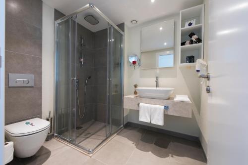 a bathroom with a shower and a toilet and a sink at Flora Garden Ephesus Kusadasi - All Inclusive in Davutlar