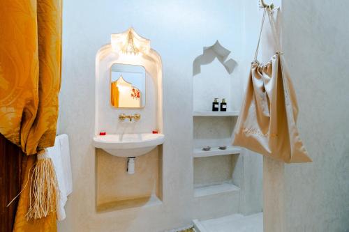 a bathroom with a sink and a mirror at Riad Asrari in Marrakech