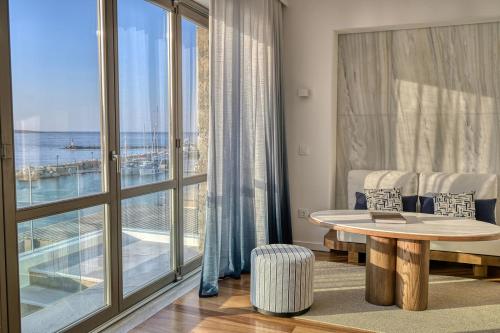 a living room with a table and a large window at Avant Mar Paros in Naousa