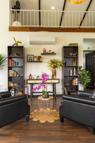 a living room with two black couches and a table at La Vista in Piedras