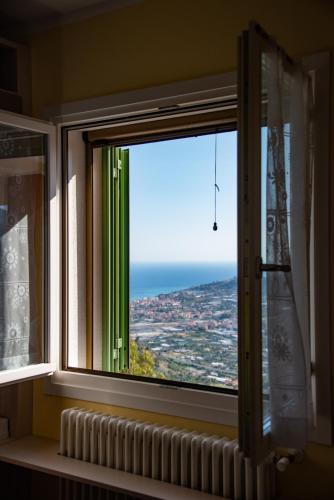 a window with a view of the ocean at Fra Cielo e Mare - Private parking & Wi-Fi in Castellaro