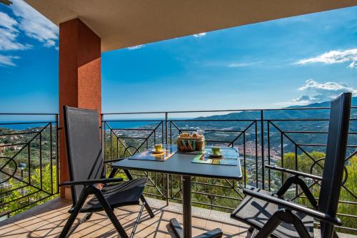 a balcony with a table and chairs and a view of the ocean at Fra Cielo e Mare - Private parking & Wi-Fi in Castellaro