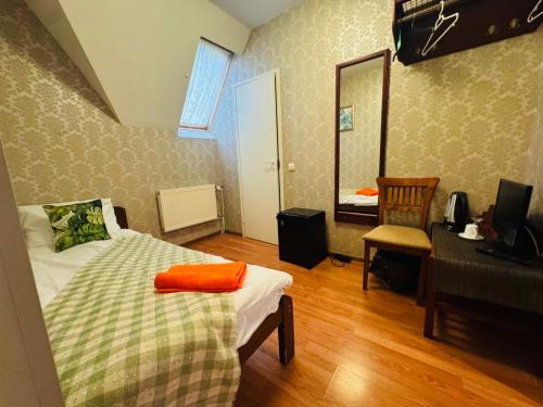 a bedroom with a bed and a desk and a mirror at I&A Residence Humala in Tallinn