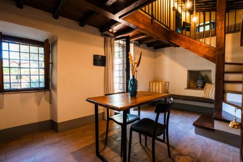 a dining room with a wooden table and chairs at Podere Dell'Arco Country Charme in Viterbo