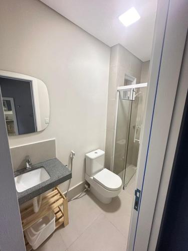 a bathroom with a toilet and a sink and a shower at Casa Ribeiro Suíte Novissíma in Boa Vista