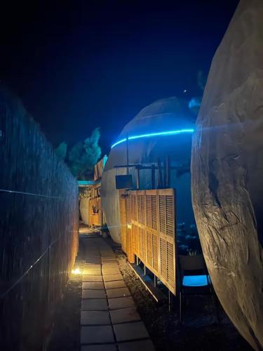 a train parked next to a wall at night at Casa Quetzal - Finca Oaxaca in Agaete