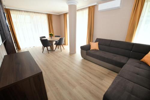 a living room with a couch and a table at Jade Hotel-Ezüsthíd Hotel in Veszprém