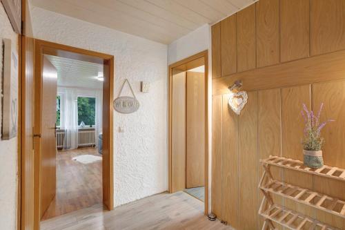 a hallway of a home with wooden walls and a door at Sara´s Ferienwohnung in Plettenberg