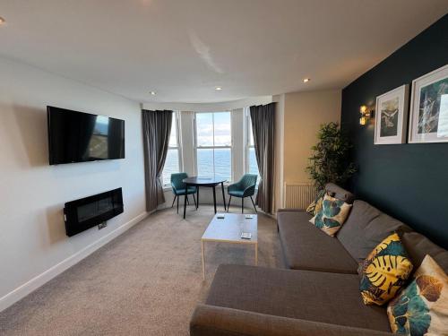 a living room with a couch and a table at The Marlborough Sea View Holiday Apartments in Scarborough