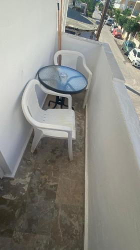 a table and two chairs sitting on a balcony at PAGONI apartments 2 in Kardamaina