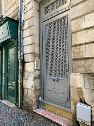 a door on the side of a building at La loge des Salinières in Bordeaux
