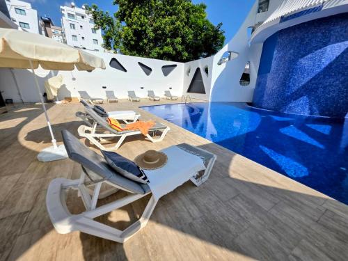 a patio with chairs and a swimming pool at City Centre Luxury Residence with Pool near Dunya IVF & Beach in Kérynia
