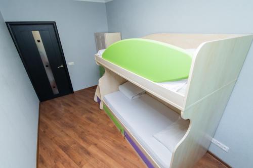 a white bunk bed with a green object on it at Seven Apartments 66 in Vyshneve