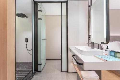 a bathroom with a sink and a shower at Holiday Inn Express Lijiang Ancient Town by IHG in Lijiang
