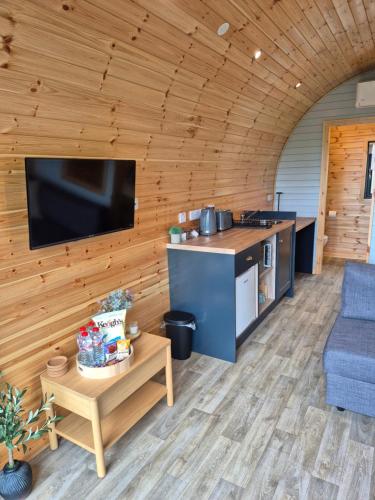 a kitchen and living room in a log cabin at Culdaff Estate Glamping in Culdaff