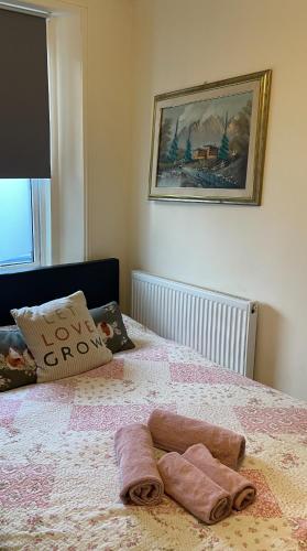 a bedroom with a bed with two towels on it at Entire Peaceful in Central London in London