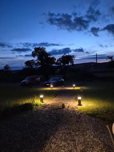 a car parked in a field at night with lights at Culdaff Estate Glamping in Culdaff
