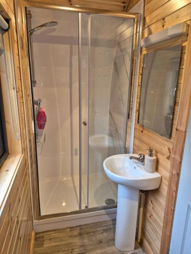 a bathroom with a shower and a sink at Culdaff Estate Glamping in Culdaff