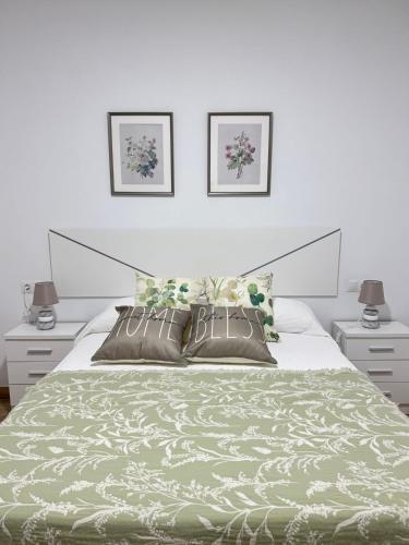 a bedroom with a large bed with two night stands at Casa en Villa Romero in Alora