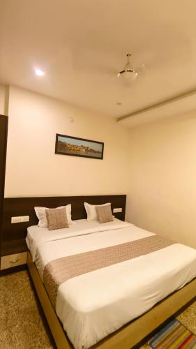 a bedroom with a large bed in a room at Hotel Udaipur Stay at Prime Location in Udaipur