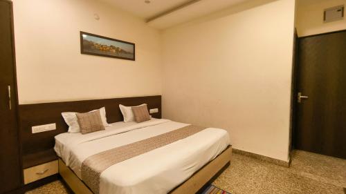 a bedroom with a large bed in a room at Hotel Udaipur Stay at Prime Location in Udaipur