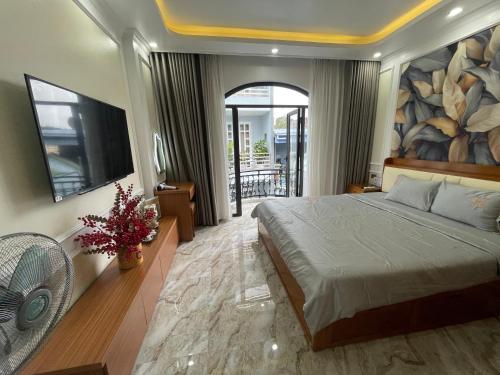 a bedroom with a large bed and a tv at Happy Hou'se in Cat Ba
