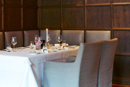 a table in a restaurant with a white table cloth at Waldhotel Stuttgart in Stuttgart