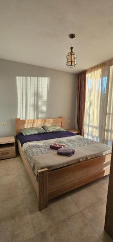 a bedroom with a large bed in front of a window at Dava&Davi in Ureki