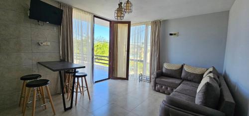 a living room with a couch and a table at Dava&Davi in Ureki