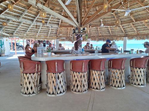 a bar in a resort with chairs and a counter at #39 Bungalow Seaside Hotel & Victors RV Park in San Felipe