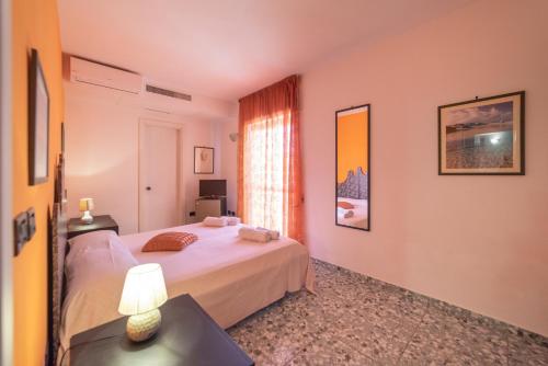a bedroom with a bed and a table with a lamp at Hotel Pietra Verde in Otranto