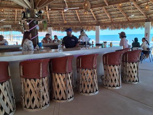 a bar in a restaurant with people sitting at it at #36 Bungalow Seaside Hotel & Victors RV Park in San Felipe