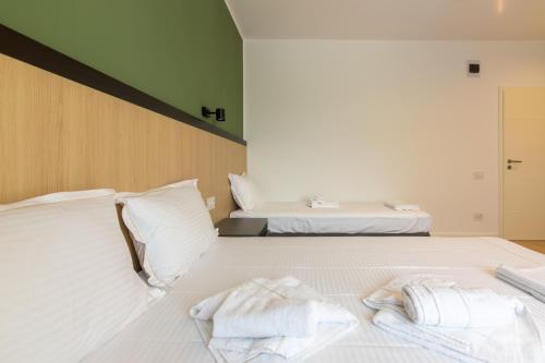 a bedroom with two beds with towels on the bed at Vila Select in Techirghiol
