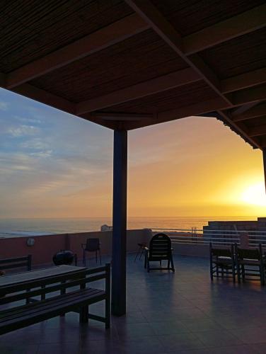 a view of the sunset from a building with benches at Mirleft Horizon Suites in Mirleft