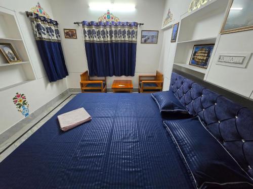 a bed in a room with a blue mattress at little Princess Guest House in Bikaner
