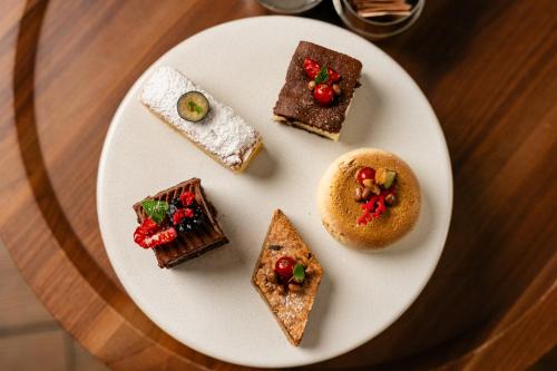 a white plate topped with different types of desserts at Waldhotel Stuttgart in Stuttgart