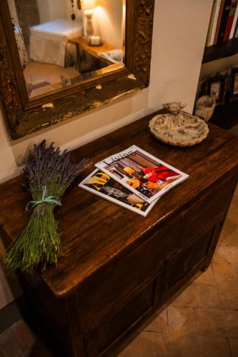 a table with a mirror and a magazine on it at Podere Dell'Arco Country Charme in Viterbo