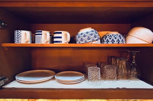 a shelf with plates and cups and other dishes at Solymar Beach Condos in Cancún